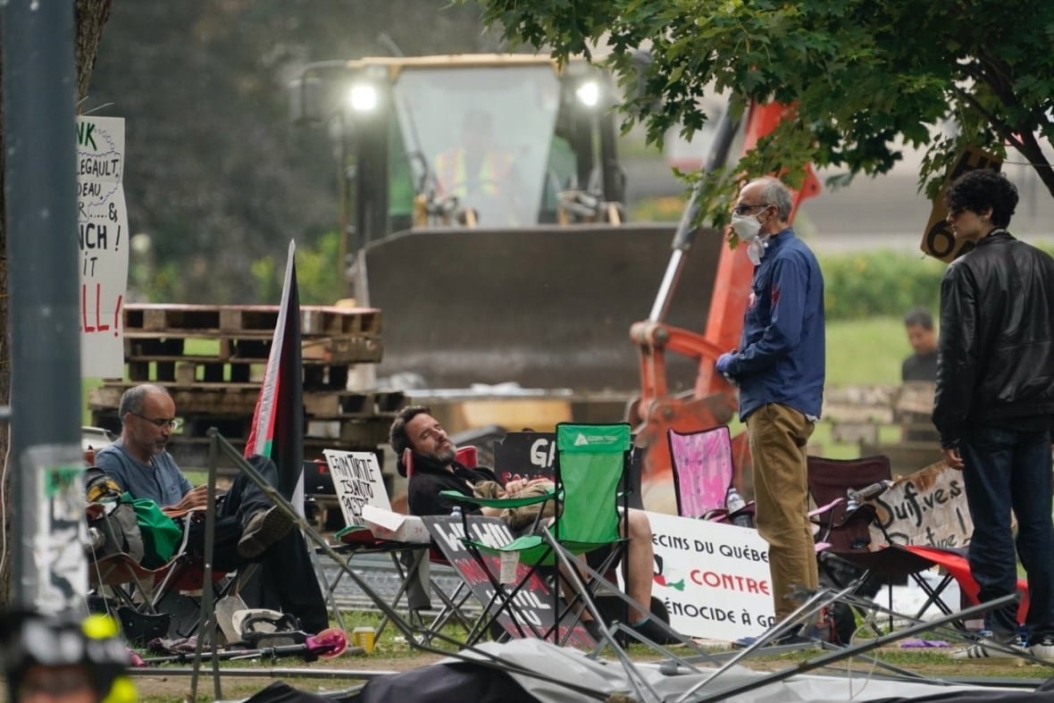 Pro-Palestinian protesters sitting on chairs as McGill encampment was being dismantled