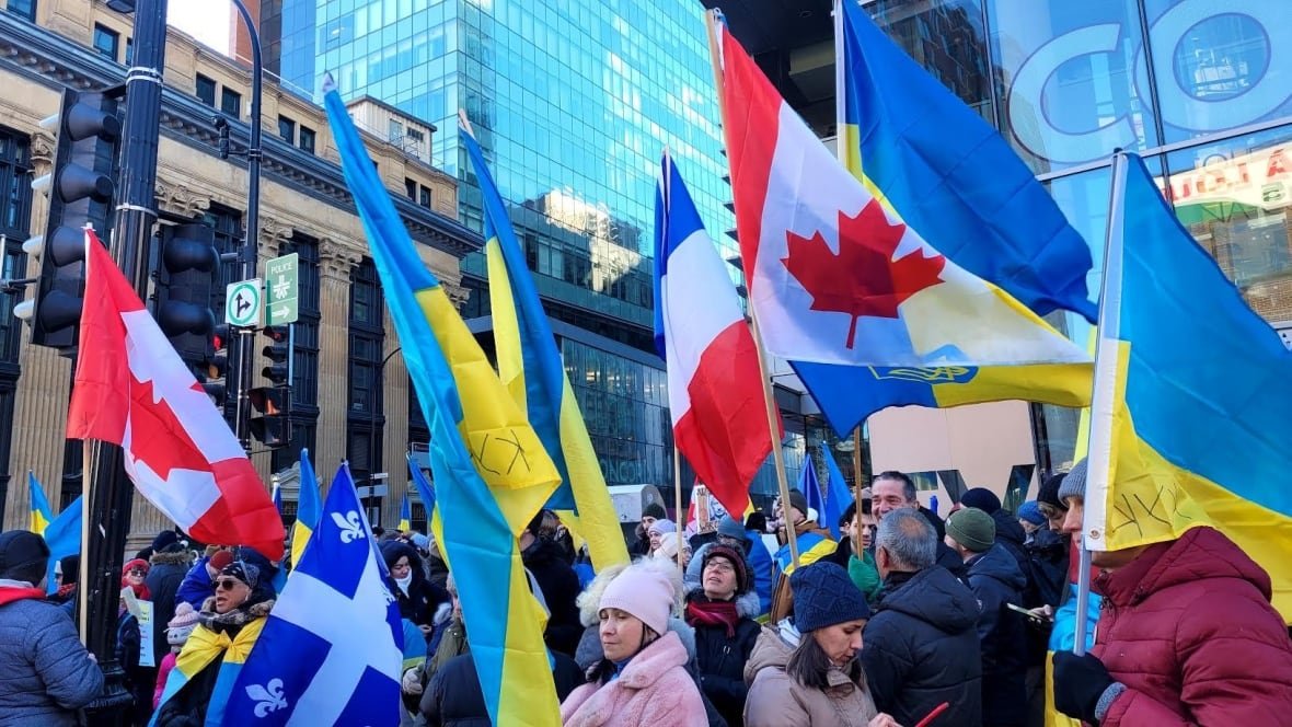 People stand in the street with flags.