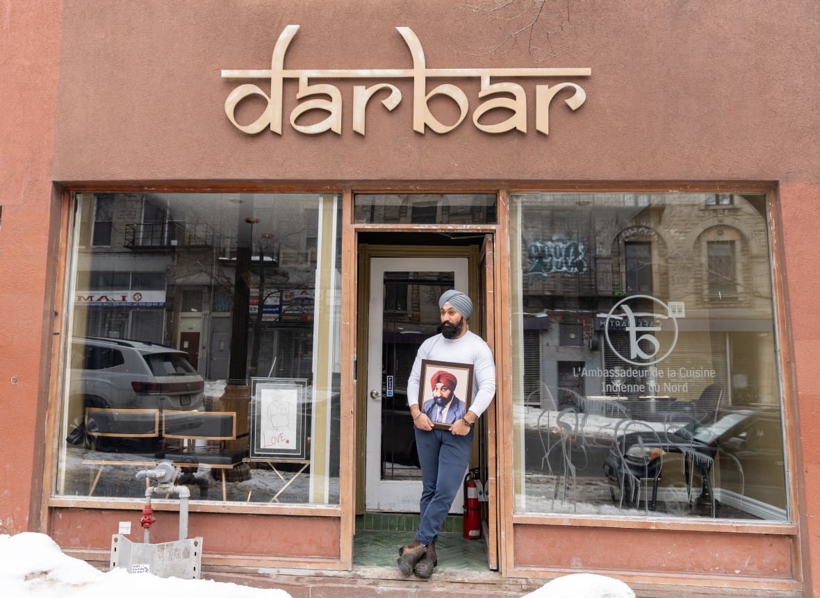 covid-anniversary-deaths-20250304 Simar Singh Anand, who calls himself a steward of legacy for his father Gurinder (Babu) Singh Anandm holds his father's photo at his restaurant in Montreal on Tuesday, March 4, 2025.