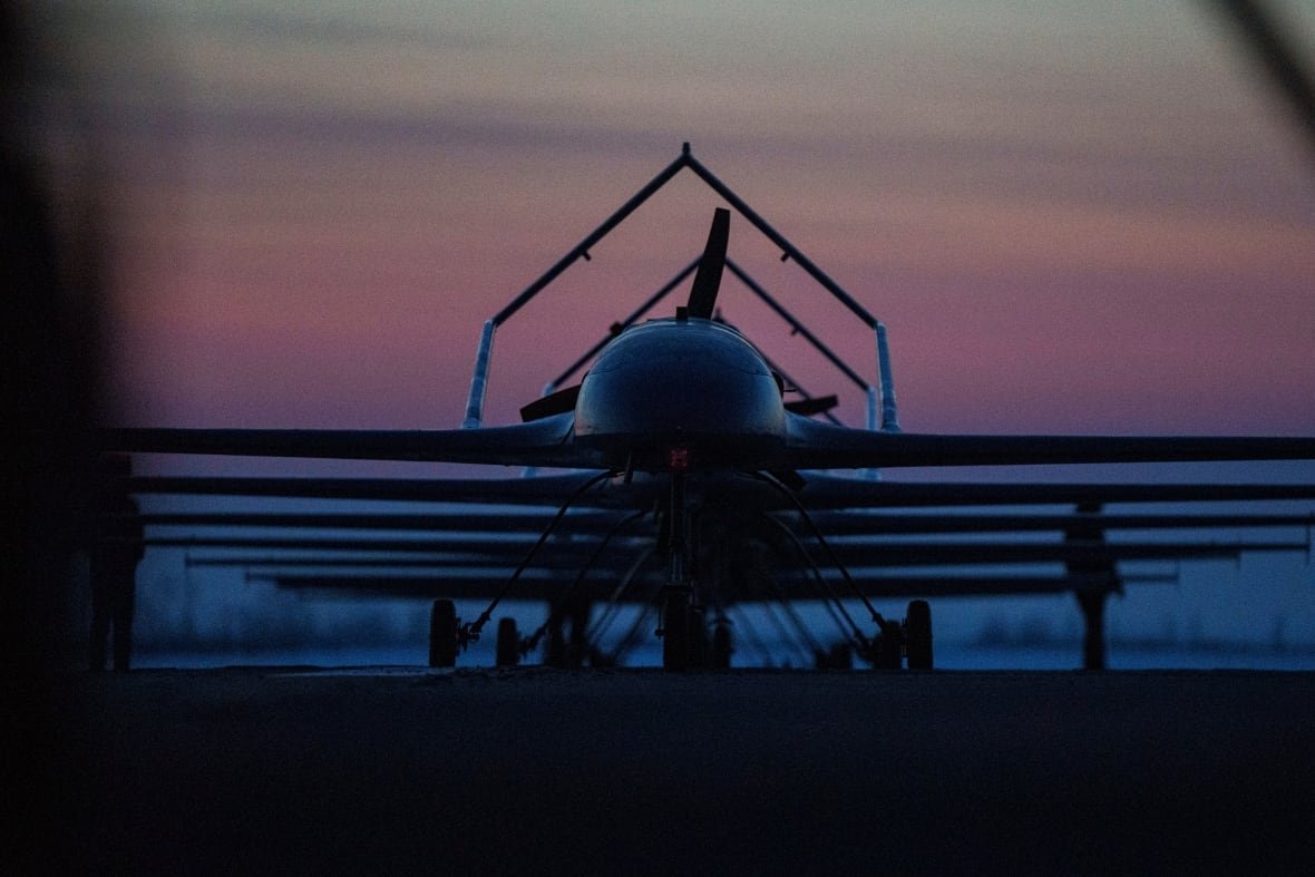 russia-ukraine-war-1 A plane is shown on a landing trip in a semi-darkened sky, either during sunrise or sunset