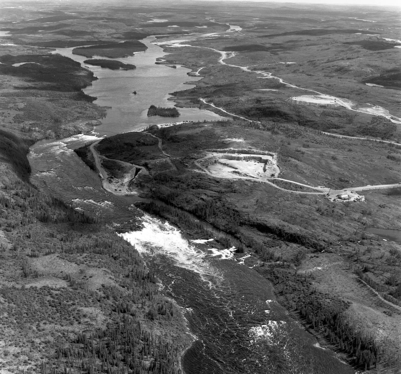 An aerial view of a river in black and white