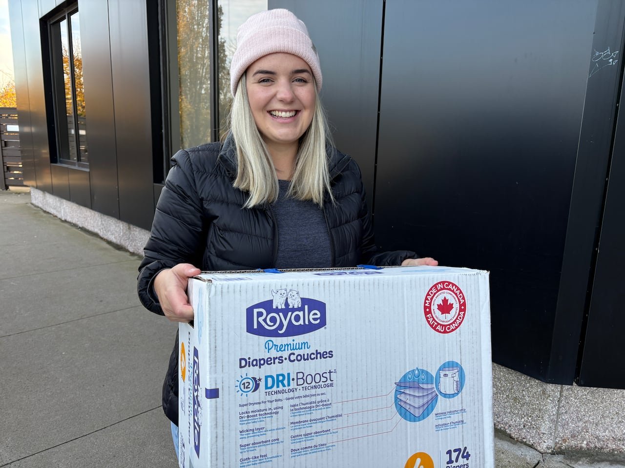 A woman delivers a box of diapers.