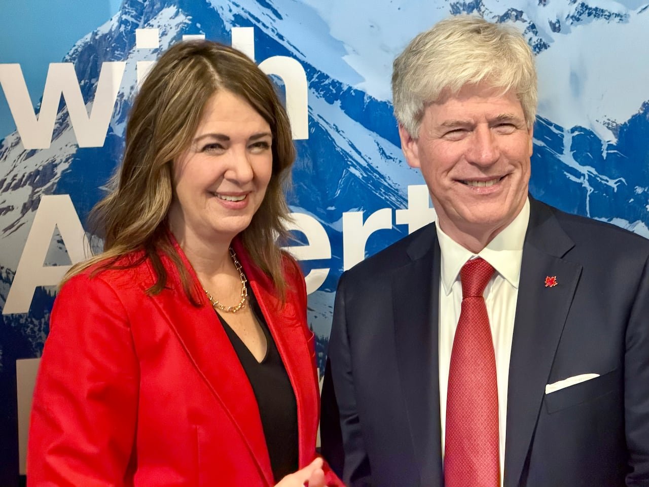 Two politicians posing for a photo together.