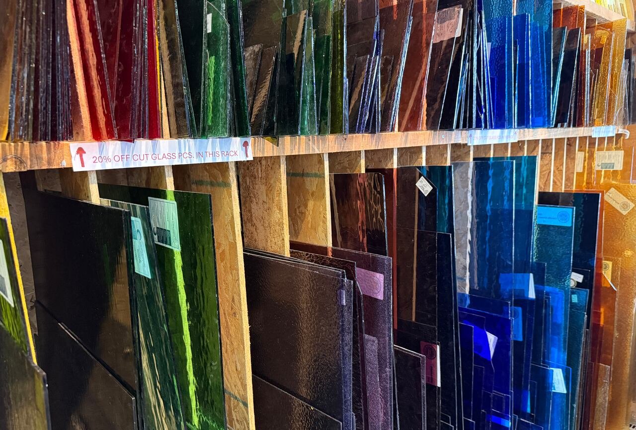 Rows of coloured stained glass for sale.