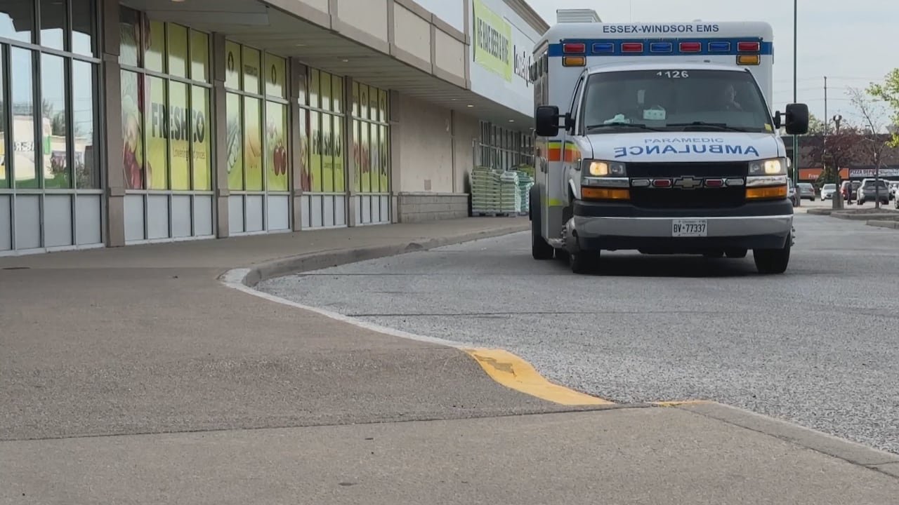 An ambulance passing by the same area in Windsor, Ontario, a day after a fatal stabbing.