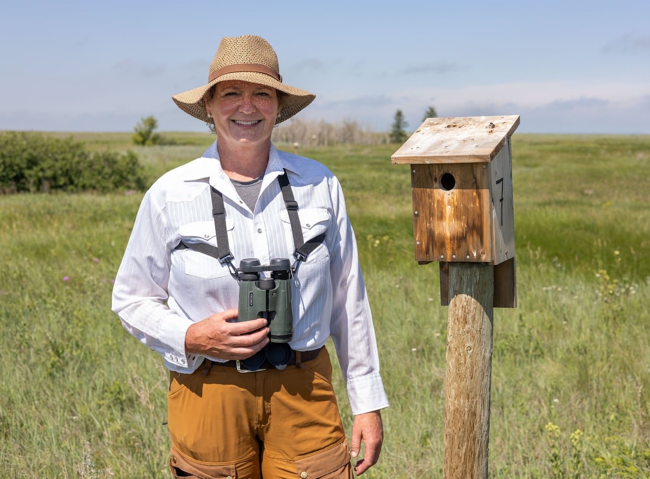 default-374 A woman stands next to a nest box.